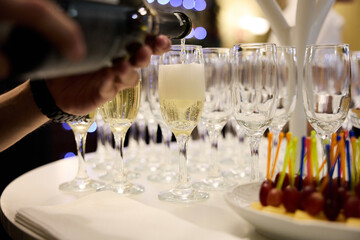Pouring champagne into elegant glass