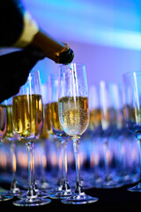 Pouring champagne into elegant glass