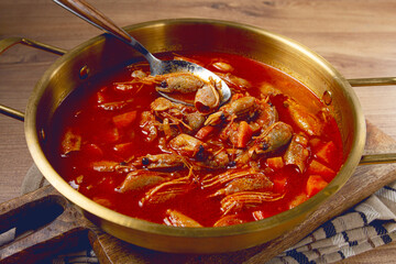 French shrimp bisque soup, in a pot, close-up, no people,