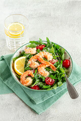 Shrimp salad with arugula and cherry tomatoes, with parmesan cheese, healthy food,