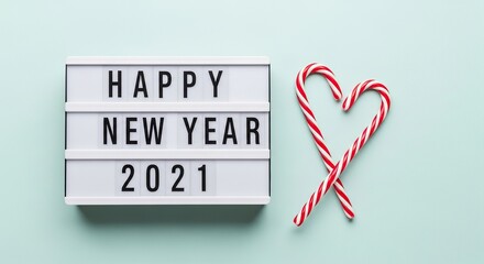 Happy new year 2021 message on a lightbox with candy canes no logo use