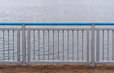 Metal fencing near a pond and park