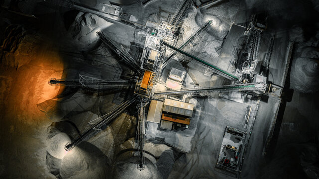 An aerial shot of a quarry plant at night, showing industrial activity and infrastructure.