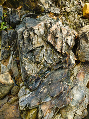 Stone wall on river bank in nature