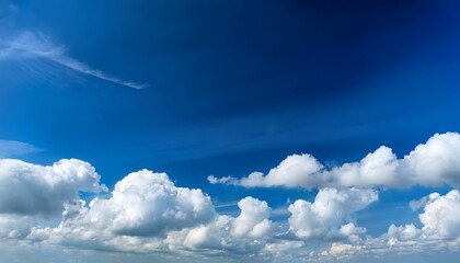 clear blue sky with fluffy white clouds in bright weather