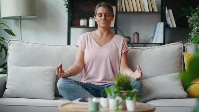 Video of relaxing woman doing yoga exercises on the couch at home