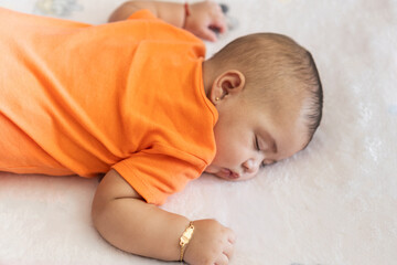 Baby infant sleeping peacefully on stomach during nap