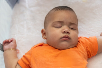 Baby peacefully sleeping, resting in white bed crib