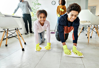 Portrait of a young black family cleaning house, family doing chores at home