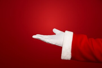 santa hand holding mockup on red background