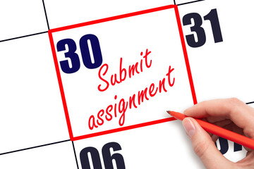 30 th day of the month.  Hand writing Submit assignment reminder and drawing red frame on calendar with red pen on white background. Business concept. Planning and scheduling