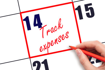 14 th day of the month.  Hand writing Track expenses reminder and drawing red frame on calendar with red pen on white background. Business concept. Planning and scheduling
