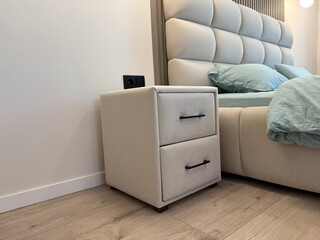 Comfortable bed with luxury bedding and stylish nightstand in bedroom