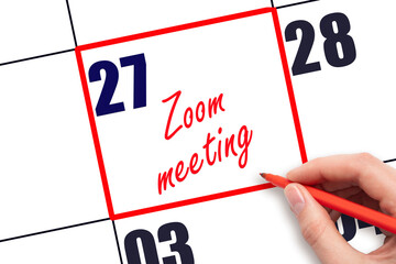 27 th day of the month.  Hand writing Zoom meeting reminder and drawing red frame on calendar with red pen on white background. Business online concept. Planning and scheduling