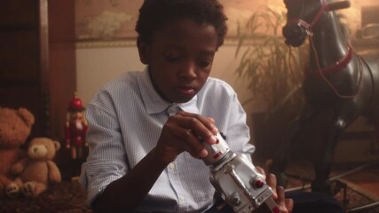 Young boy enjoys playing with a toy robot in a cozy playroom setting
