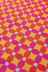 Bright geometric floor pattern with flower shapes.