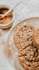Three cookies with a brownish color and a sprinkle of cinnamon on top
