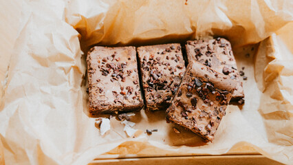 A box of brownies with chocolate chips on top