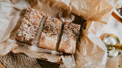 Three pieces of cake are sitting on top of a brown paper bag