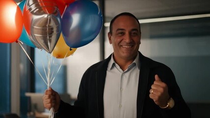 Joyful celebration with colorful balloons and smiling man indoors - Powered by Adobe