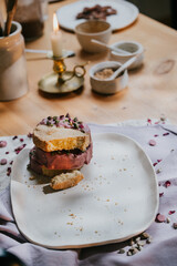 A plate of dessert with a candle on the table