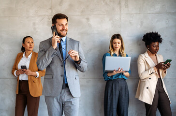Multicultural professional businesspeople working together on research plan in boardroom.