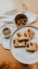 A plate of four peanut butter cookies sits on a wooden table