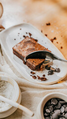 A plate of brownies with a spoon on it