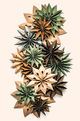Eco Christmas paper ornaments from kraft and recycled paper — origami stars in green and natural tones, minimalist flat lay for sustainable holiday decor, zero-waste concept