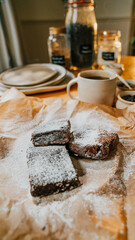 A plate of brownies with powdered sugar on top