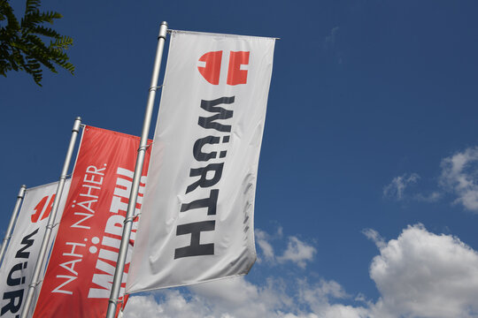 N&ouml;rdlingen, Bavaria, Germany - July 4, 2025: W&uuml;rth flags in N&ouml;rdlingen, Germany - W&uuml;rth Group is a worldwide wholesaler of fasteners, screws and screw accessories