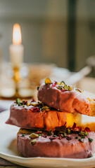 Three pink donuts with green sprinkles on top