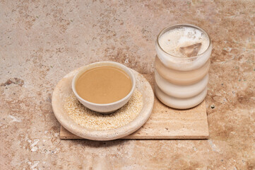 Coffee with sesame paste tahini in a cup on the Travertine table