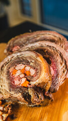 Juicy stuffed beef ribs with calabrese sausage, bacon and vegetables. Golden brown and perfectly cooked, tied with twine. Ideal for gourmet menus and meat promotions.