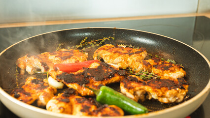 Boneless chicken thighs sizzling in a pan, developing a golden brown crust. Juicy and perfectly cooking. Ideal for meals, salads, or quick dinners.