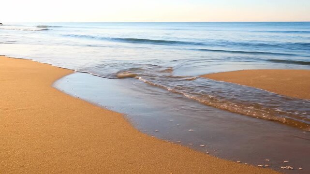 Peaceful ocean tide ebbing and flowing on a sandy beach, revealing wet patterns over time untouched, earth, relaxation
