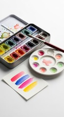 Watercolor Paint Set with Brush and Color Swatches on White Background
