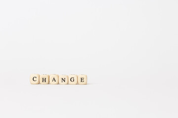 Wooden blocks spelling change on a minimalistic background, symbolizing transformation and innovation in finance and technology sectors. copy space