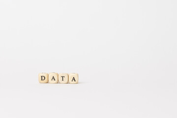 Wooden blocks spelling data on a clean white background, representing technology, finance, and the importance of information in modern business. copy space