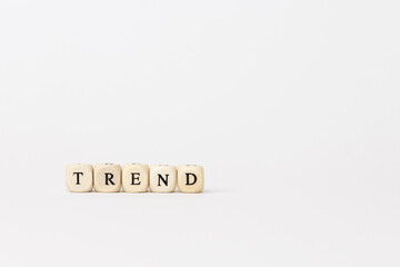 Trend letters displayed on wooden cubes against a minimalistic background, representing modern finance and technology concepts with copy space. copy space