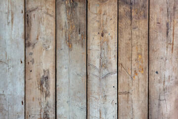 Aged wooden boards scarred with tool marks form a rustic textured background. Graphic resource or backdrop