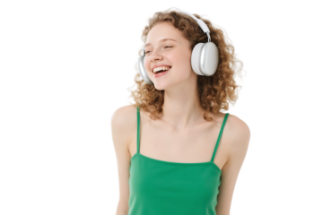 A woman with curly hair wearing white headphones is smiling while enjoying music.