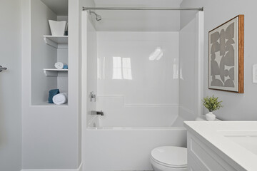 Bathroom with a white toilet and bathtub