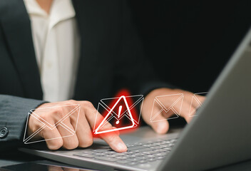 A businessman using a computer to receive email warning alerts about spam, junk and trash mail, hacker and virus. Concepts of network security
