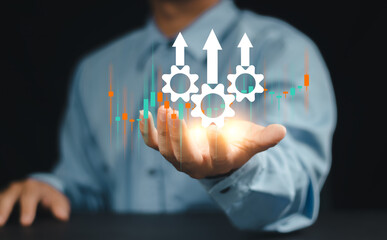 Process improvement and productivity growth concept. A businessman holds gears and upward arrows, symbolizing process optimization, productivity growth, efficient processes, and business efficiency.