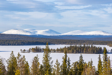 Aerial landscape view into snowy mountains in Finland's Lapland.