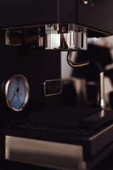 Modern black coffee machine preparing espresso in a stylish home kitchen