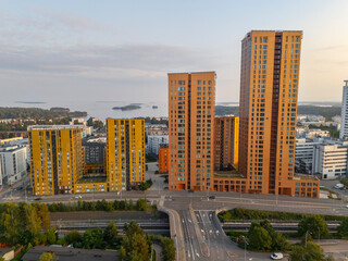 Aerial view to new residential towers in Vuosaari, Helsinki and the sea view opening up behind them. © Julius