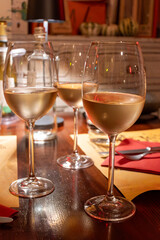 Drinking of white wine in restaurant for dinner, glasses of white wine in Italy, France, European lifestyle