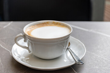 White cup of italian coffee cappuccino served in cafe in Milano, Italy